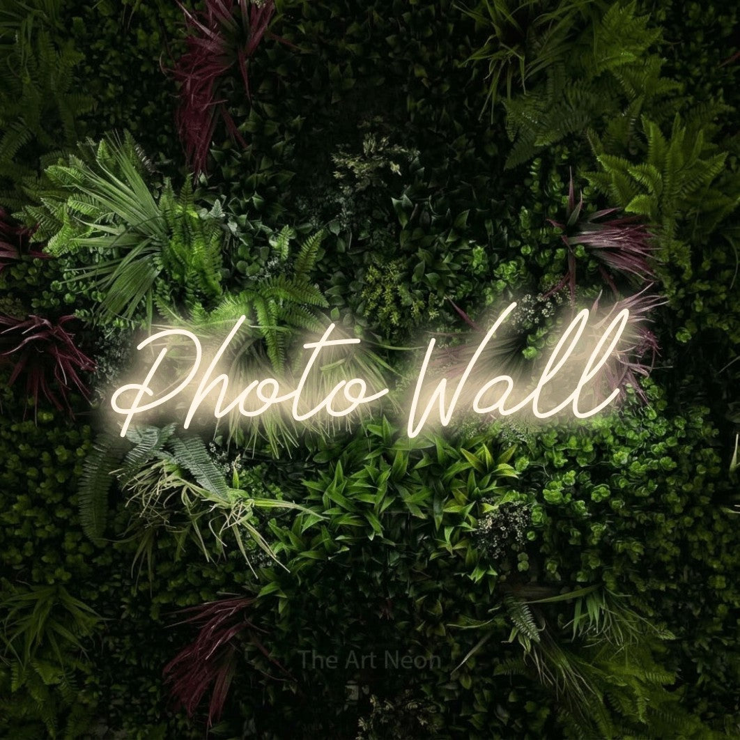 LED neon sign reading “Photo Wall”, arranged in a single line.