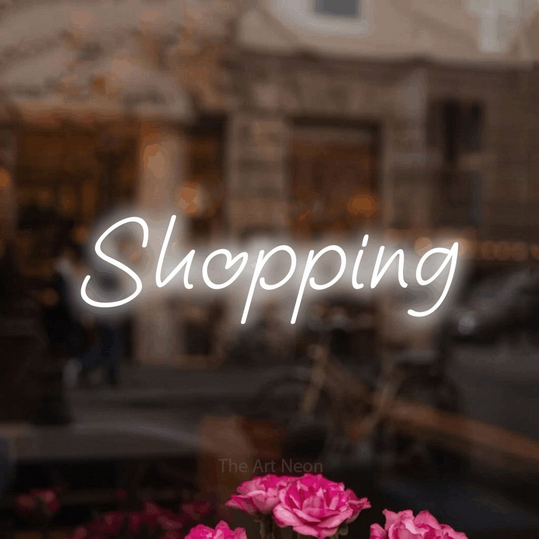 LED neon sign reading “Shopping”, arranged in a single line.