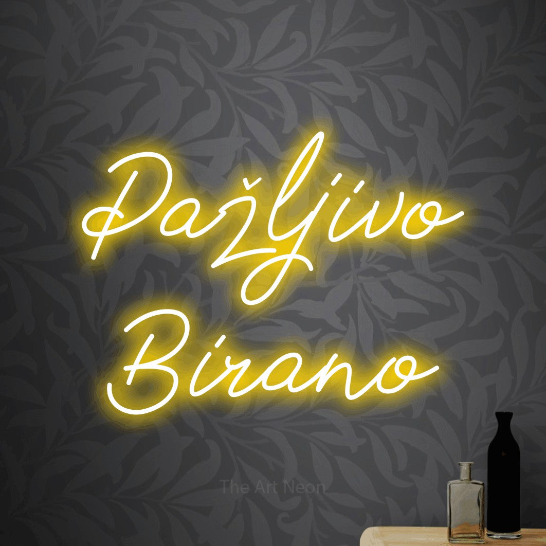 LED neon sign reading “Pažljivo Birano”, arranged in two lines.