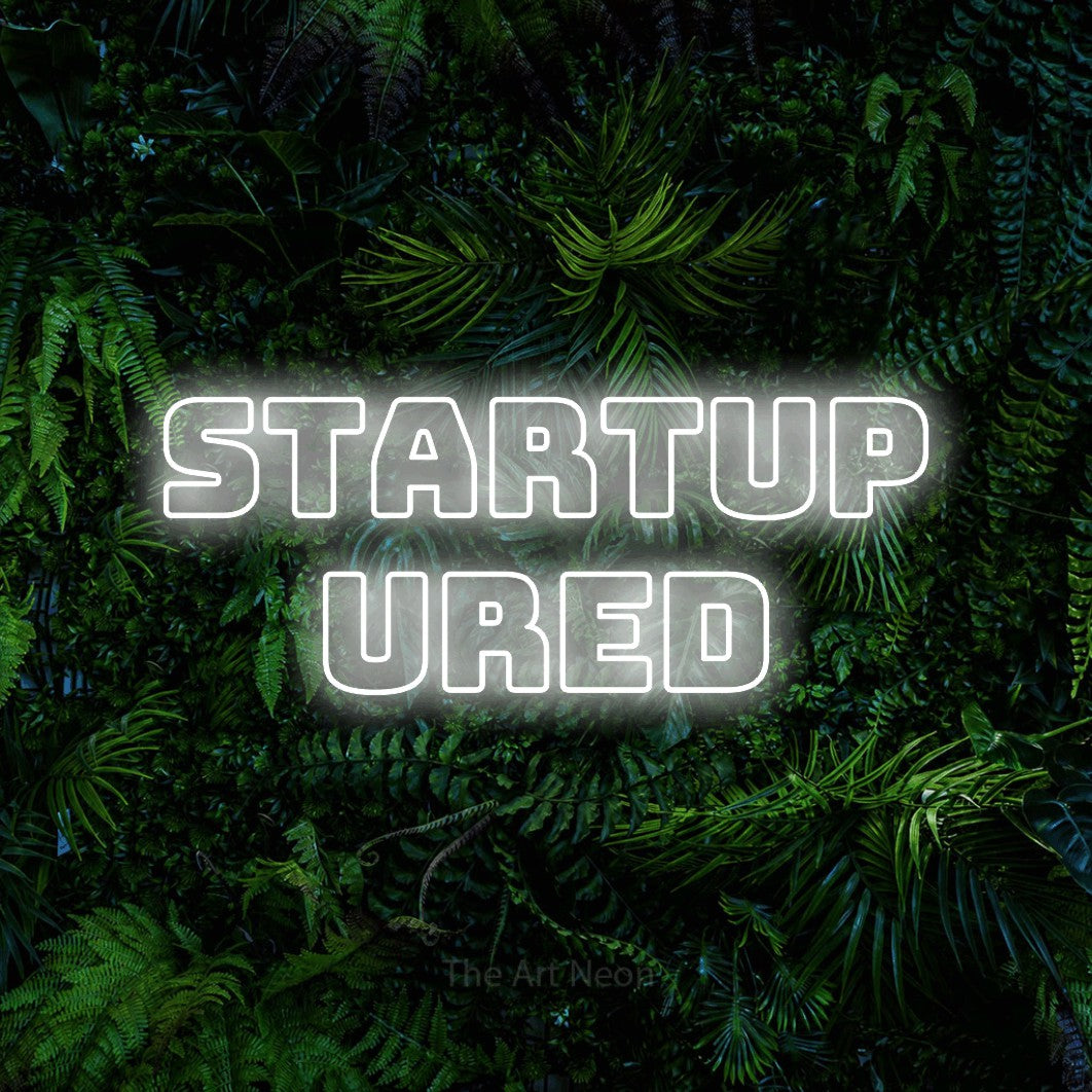 LED neon sign reading “startup ured”, arranged in two lines.