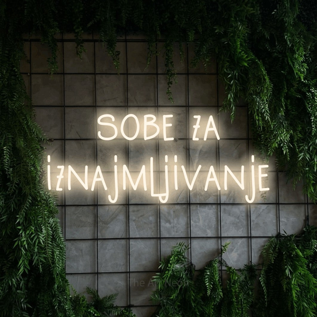 LED neon sign reading “sobe za iznajmljivanje”, arranged in two lines.