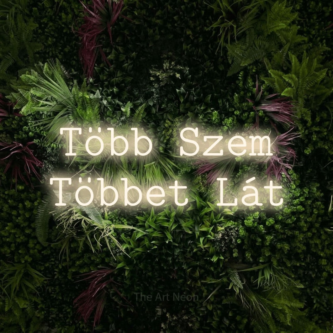 LED neon sign reading “Több Szem Többet Lát”, arranged in two lines.