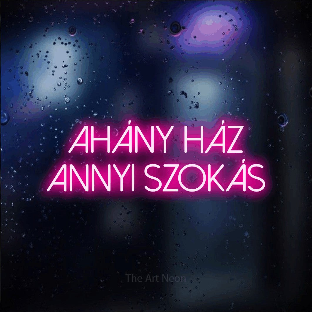LED neon sign reading “ahány ház annyi szokás”, arranged in two lines.