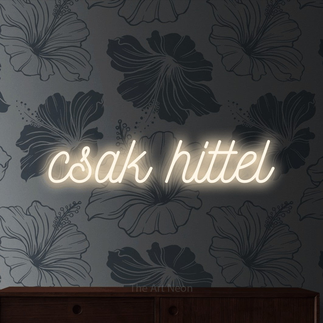 LED neon sign reading “csak hittel”, arranged in a single line.