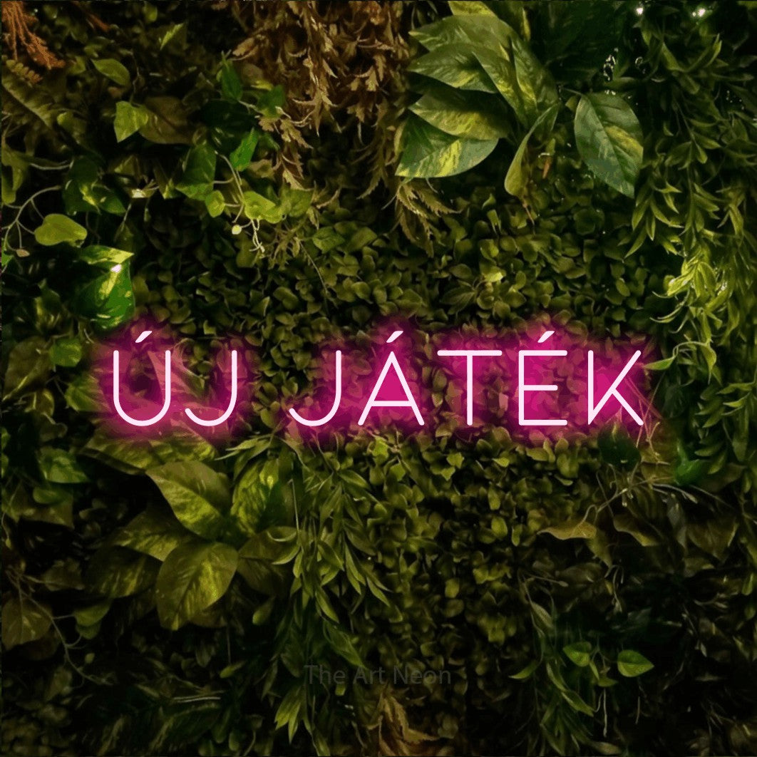 LED neon sign reading “Új játék”, arranged in a single line.