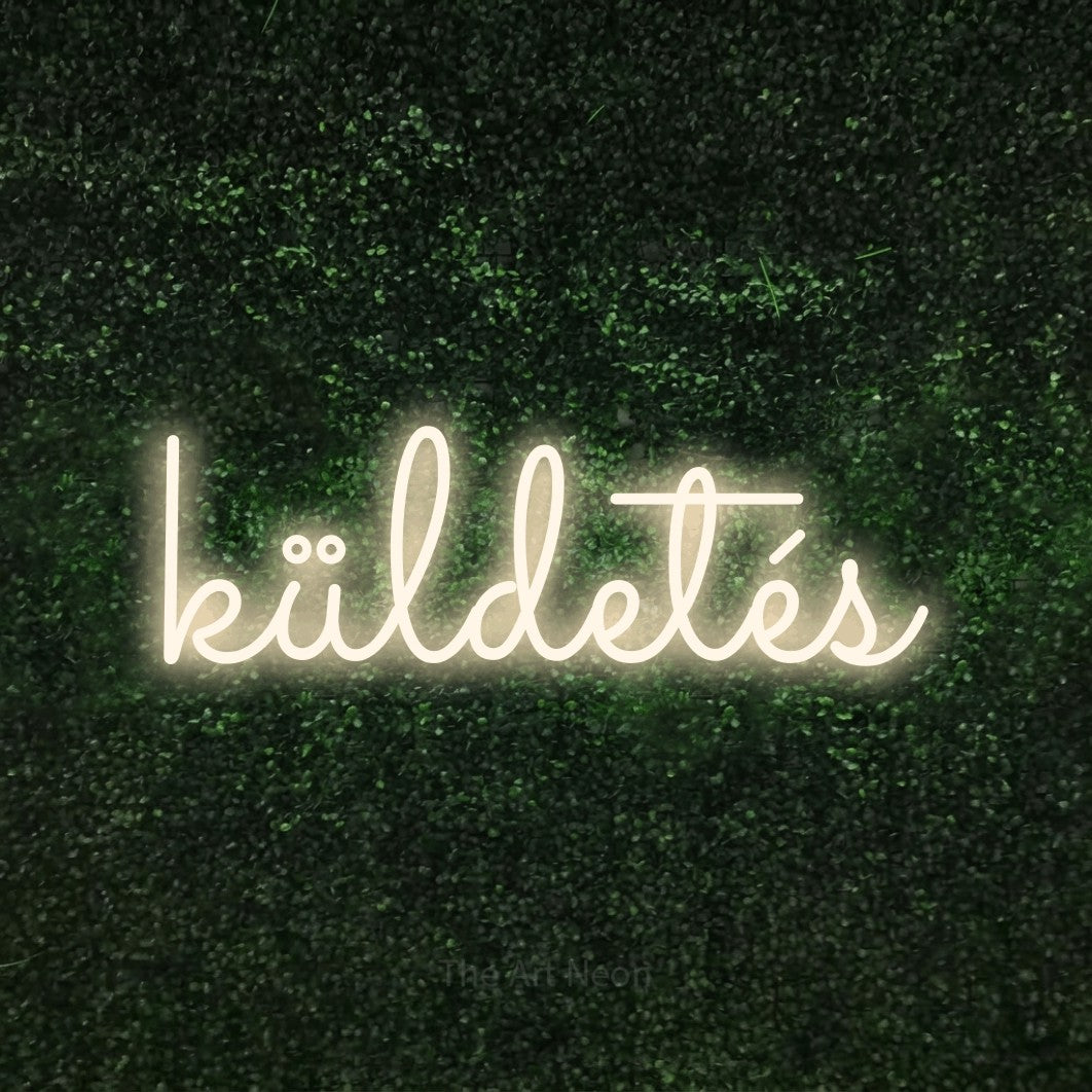 LED neon sign reading “küldetés”, arranged in a single line.