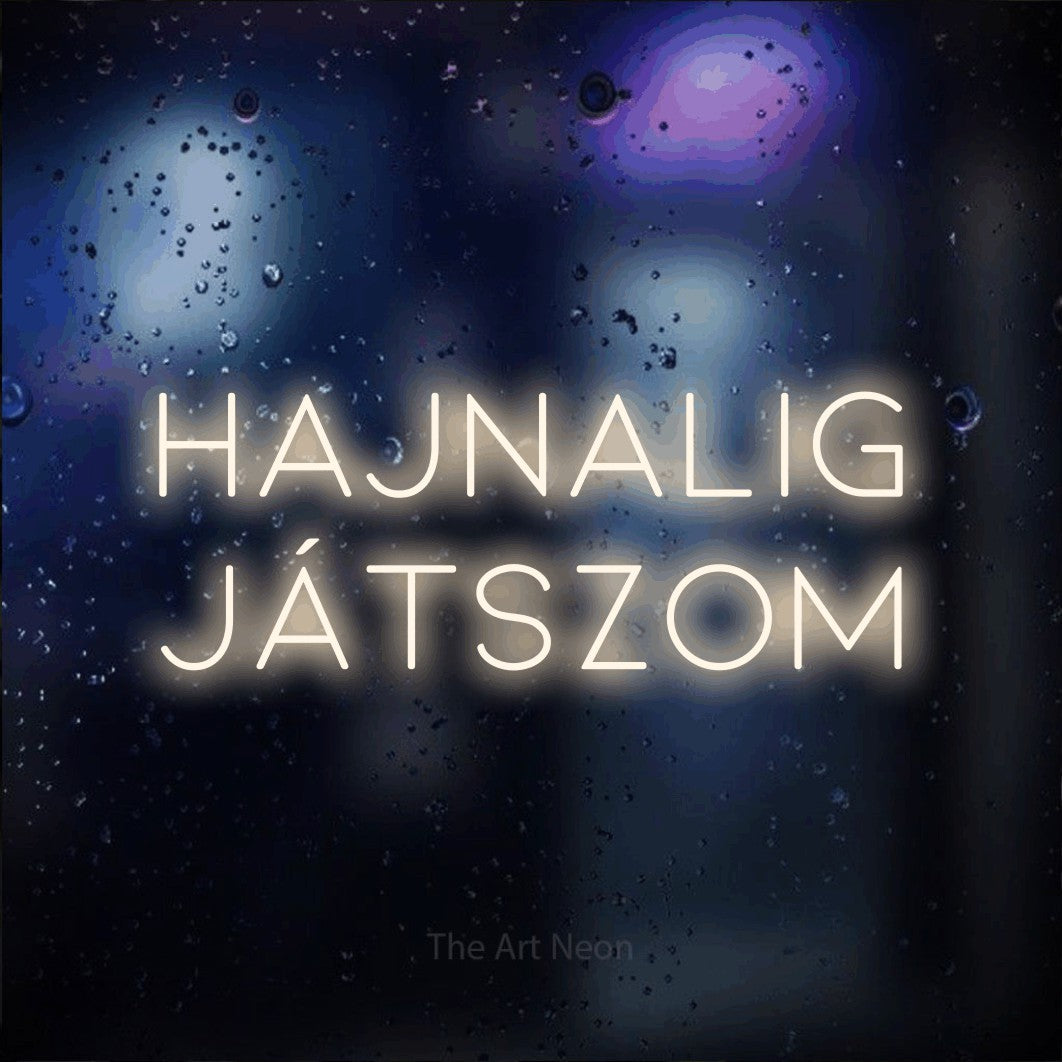 LED neon sign reading “HAJNALIG JÁTSZOM”, arranged in two lines.