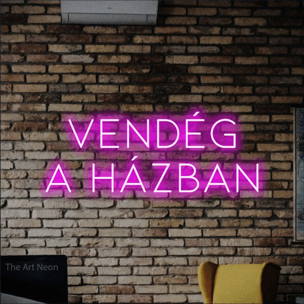 LED neon sign reading “VENDÉG A HÁZBAN”, arranged in two lines.