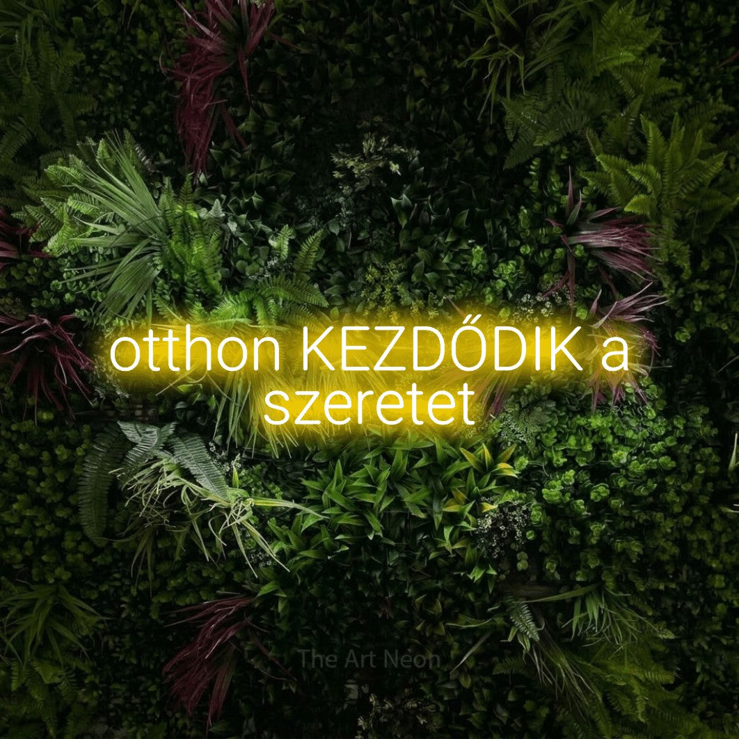 LED neon sign reading “otthon KEZDŐDIK a szeretet”, arranged in two lines.