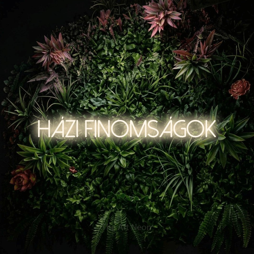 LED neon sign reading “HÁZI FINOMSÁGOK”, arranged in a single line.