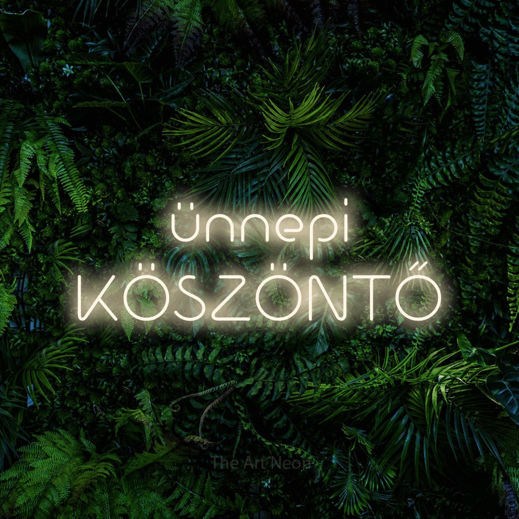 LED neon sign reading “ünnepi KÖSZÖNTŐ”, arranged in two lines.