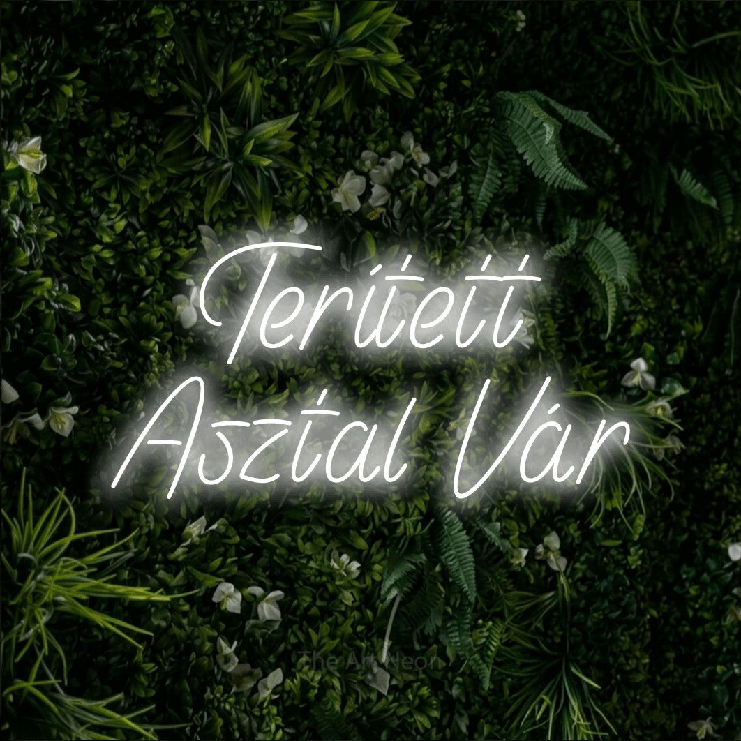 LED neon sign reading “Terített Asztal Vár”, arranged in two lines.