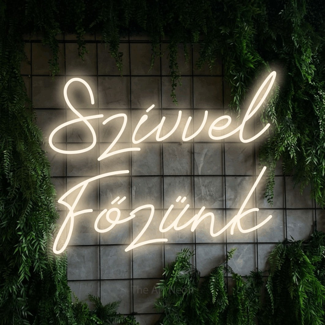 LED neon sign reading “Szívvel Főzünk”, arranged in two lines.