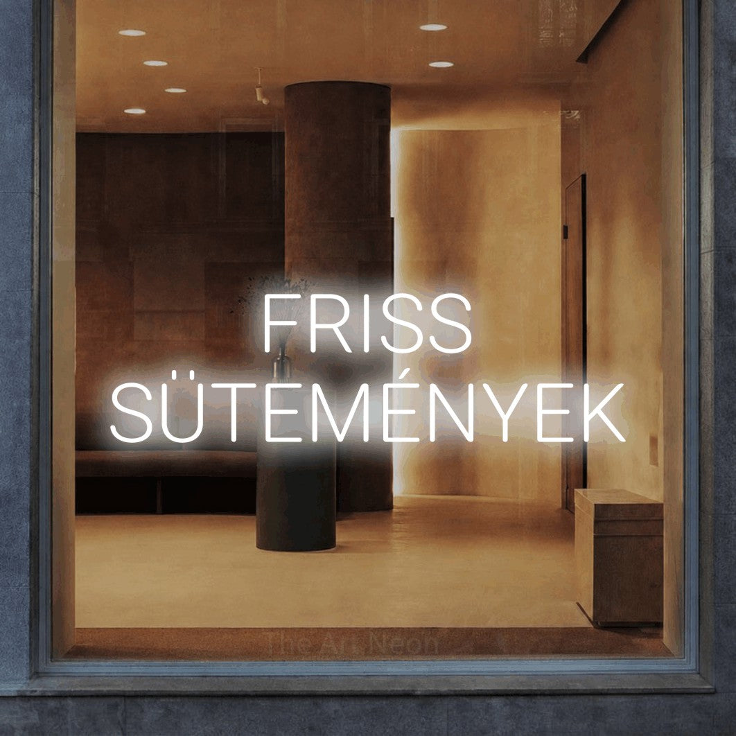 LED neon sign reading “FRISS SÜTEMÉNYEK”, arranged in two lines.