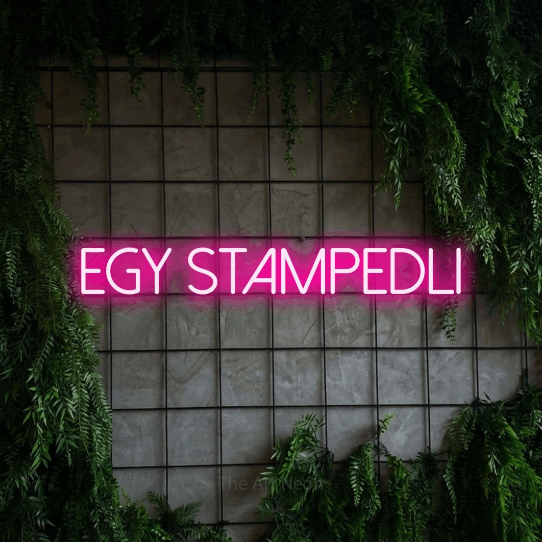 LED neon sign reading “EGY STAMPEDLI”, arranged in a single line.