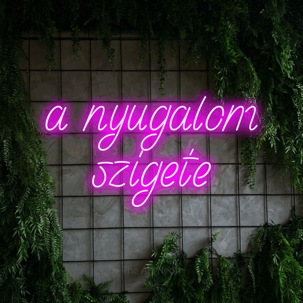 LED neon sign reading “a nyugalom szigete”, arranged in two lines.