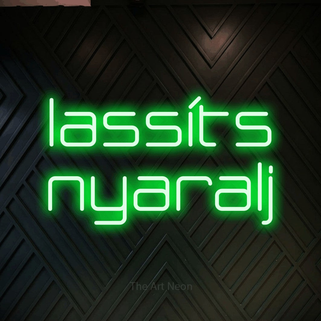 LED neon sign reading “lassíts nyaralj”, arranged in two lines.