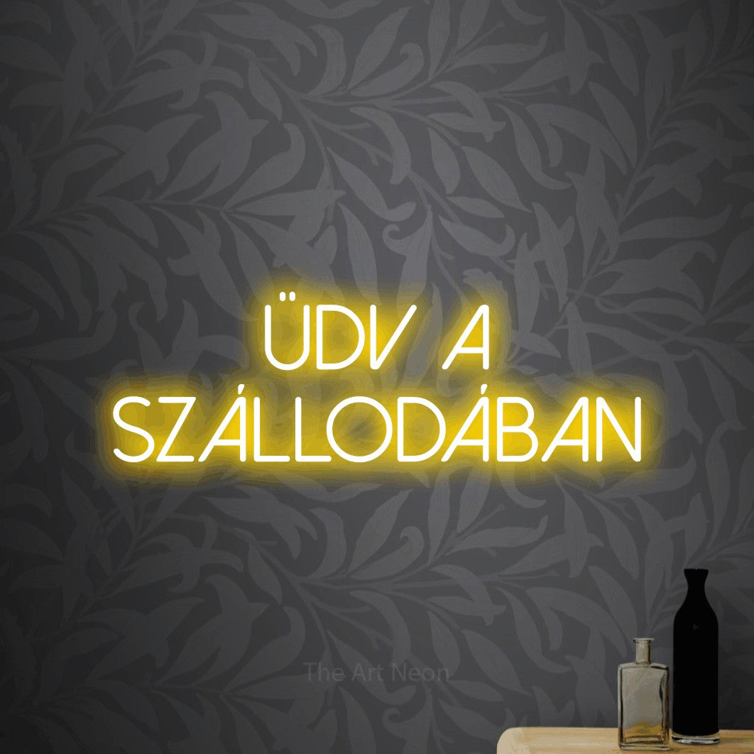 LED neon sign reading “ÜDV A SZÁLLODÁBAN”, arranged in two lines.