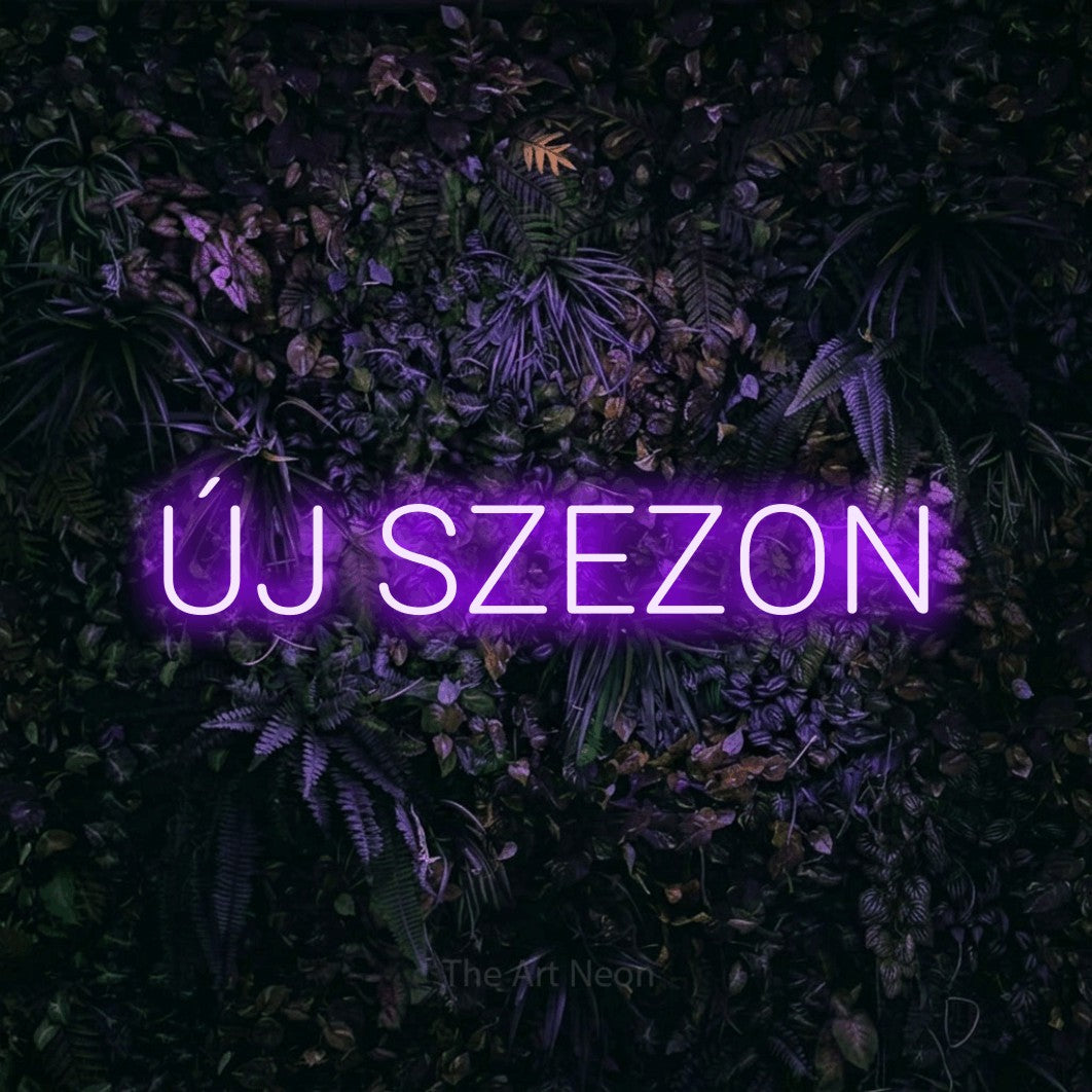 LED neon sign reading “ÚJ SZEZON”, arranged in a single line.