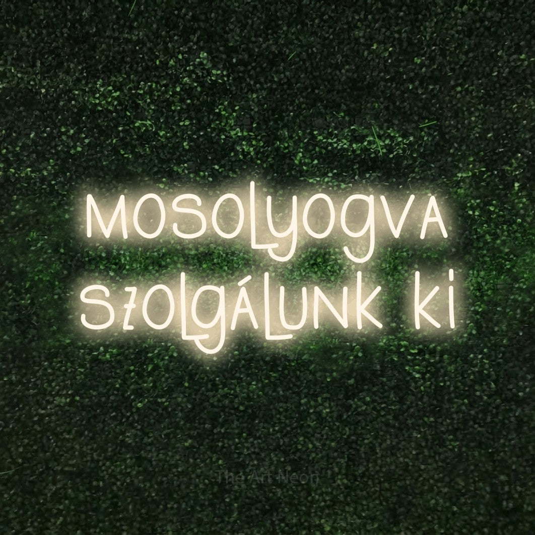 LED neon sign reading “mosolyogva szolgálunk ki”, arranged in two lines.