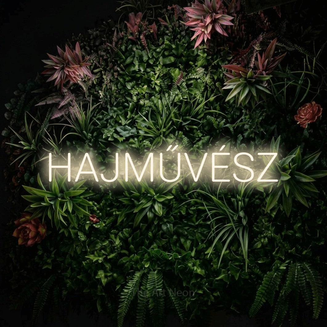 LED neon sign reading “HAJMŰVÉSZ”, arranged in a single line.
