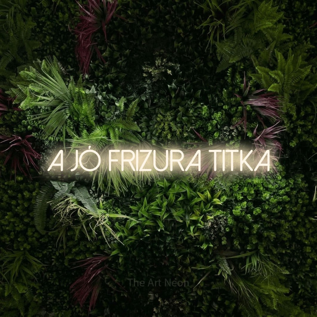 LED neon sign reading “a jó frizura titka”, arranged in a single line.