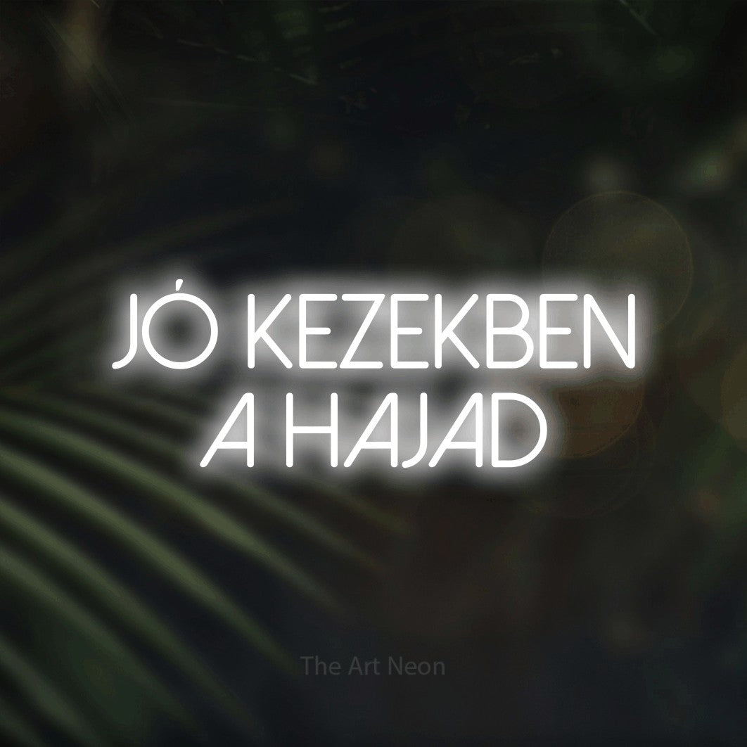 LED neon sign reading “Jó Kezekben A Hajad”, arranged in two lines.