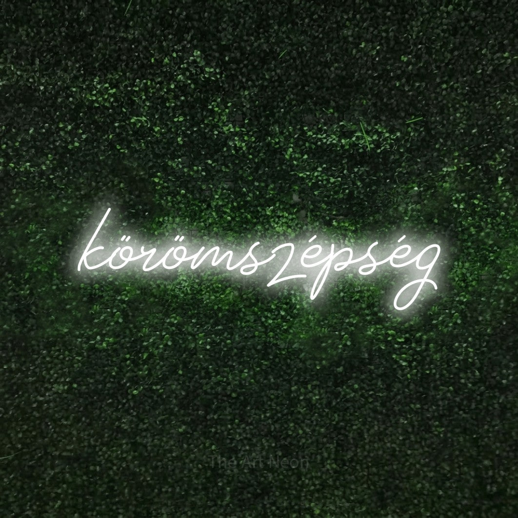 LED neon sign reading “körömszépség”, arranged in a single line.