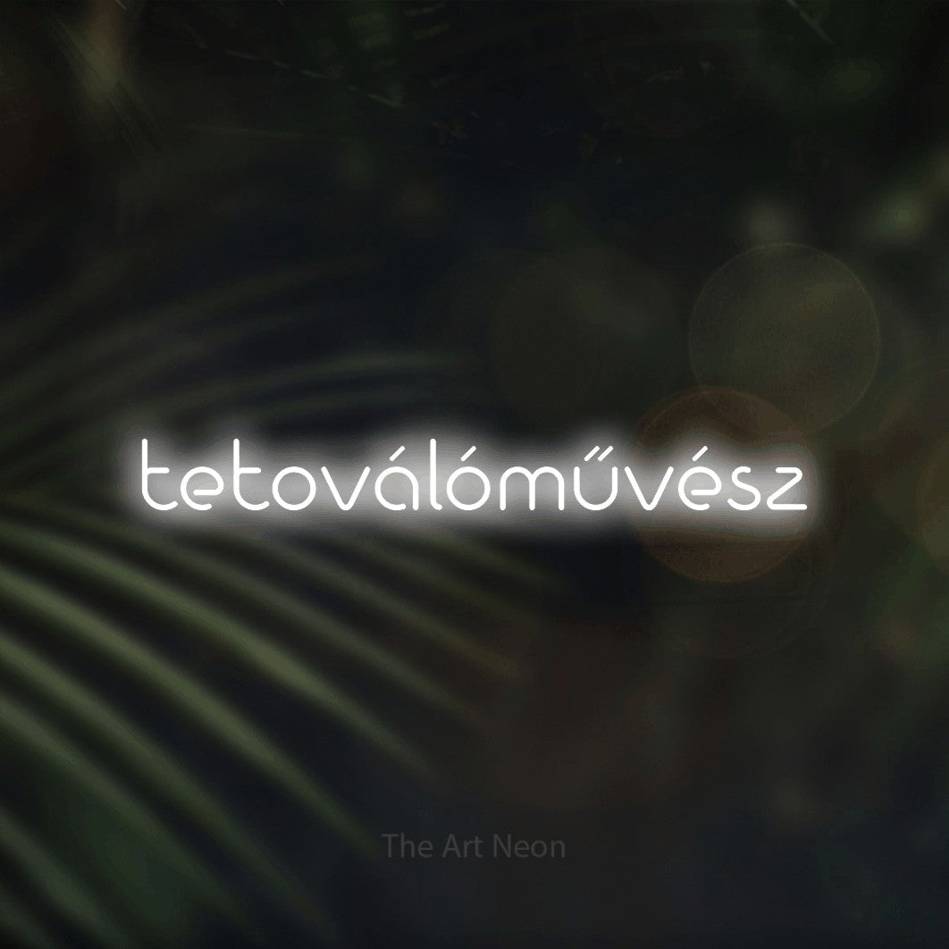 LED neon sign reading “tetoválóművész”, arranged in a single line.