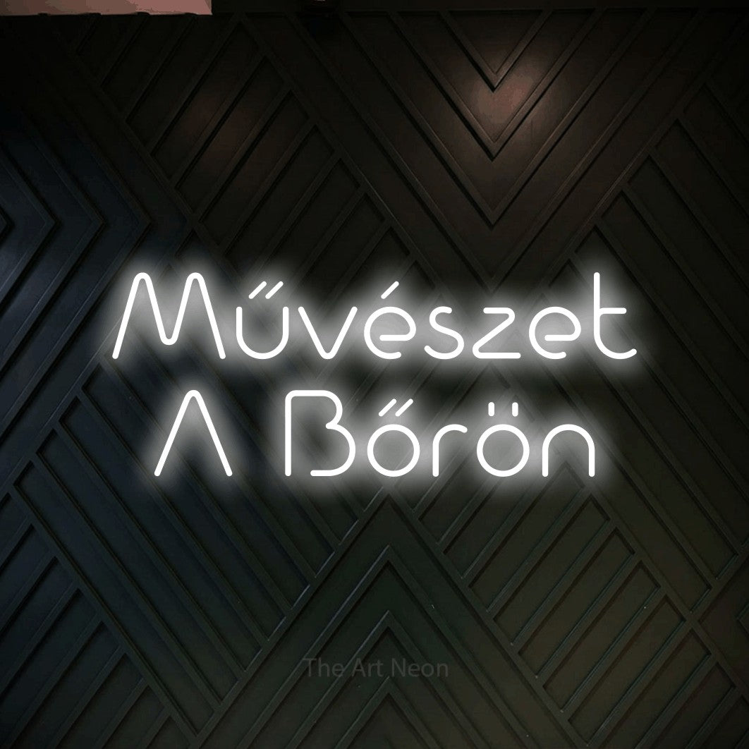 LED neon sign reading “Művészet A Bőrön”, arranged in two lines.