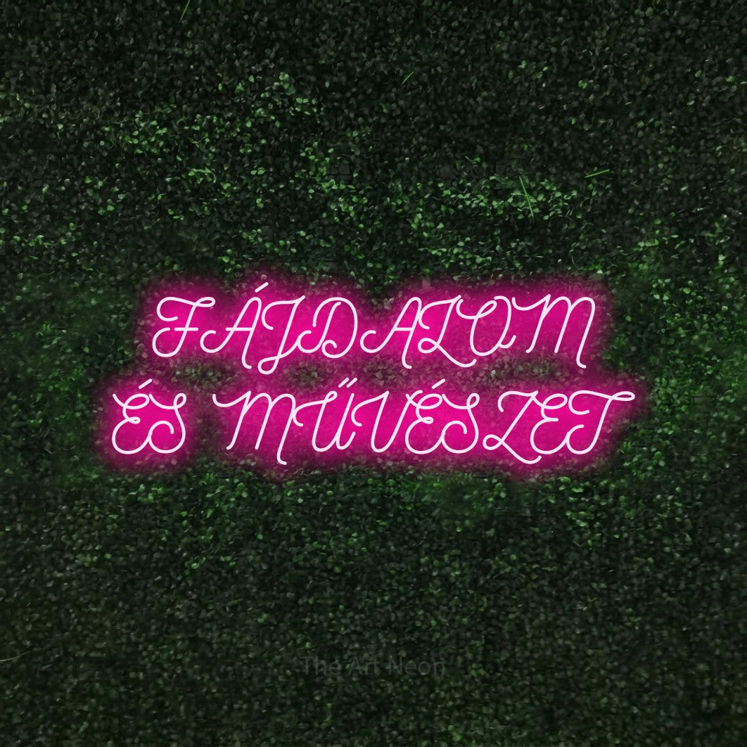 LED neon sign reading “FÁJDALOM ÉS MŰVÉSZET”, arranged in two lines.