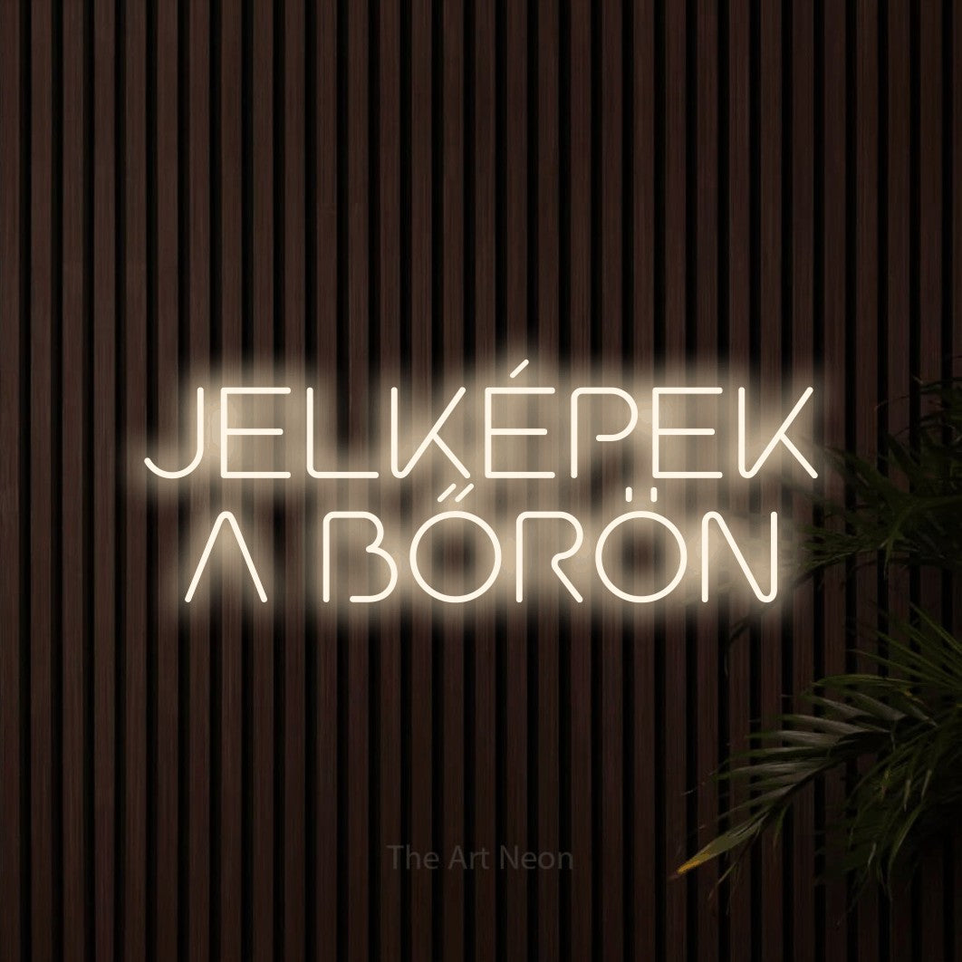 LED neon sign reading “JELKÉPEK A BŐRÖN”, arranged in two lines.