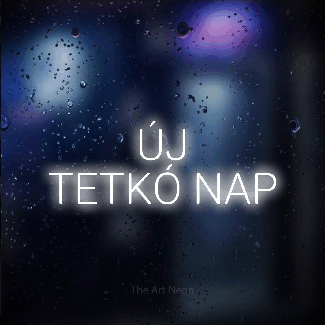 LED neon sign reading “ÚJ TETKÓ NAP”, arranged in two lines.