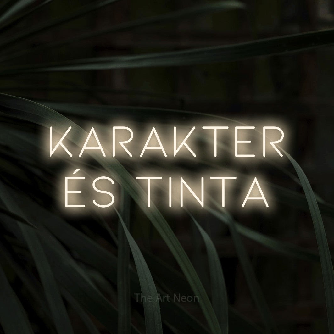 LED neon sign reading “karakter és tinta”, arranged in two lines.