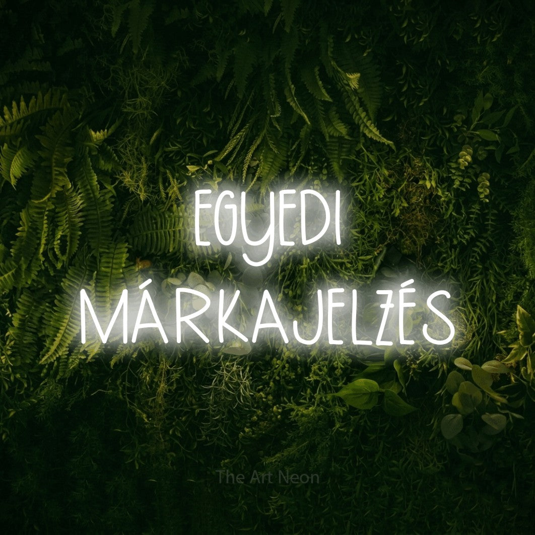 LED neon sign reading “EGYEDI MÁRKAJELZÉS”, arranged in two lines.