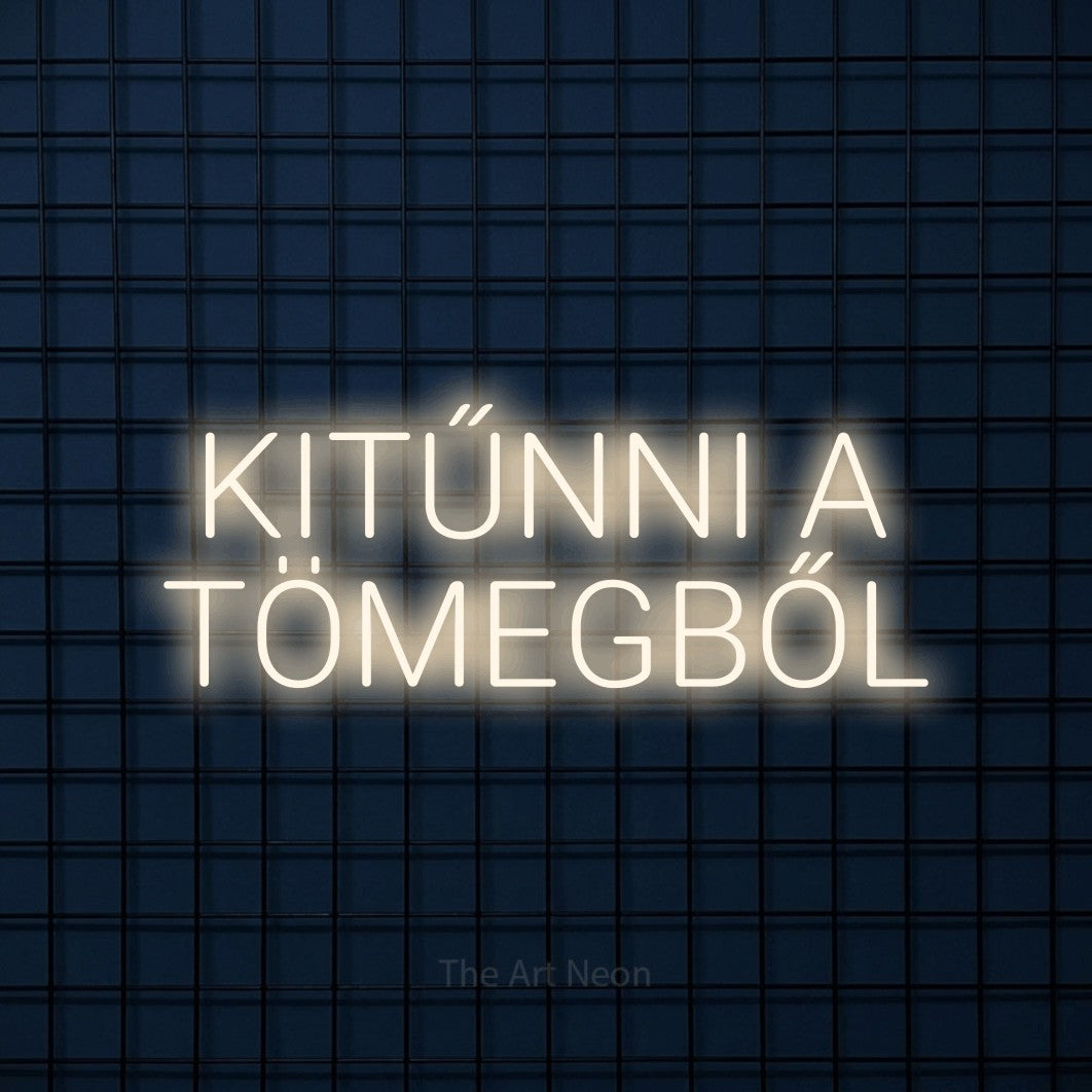 LED neon sign reading “KITŰNNI A TÖMEGBŐL”, arranged in two lines.