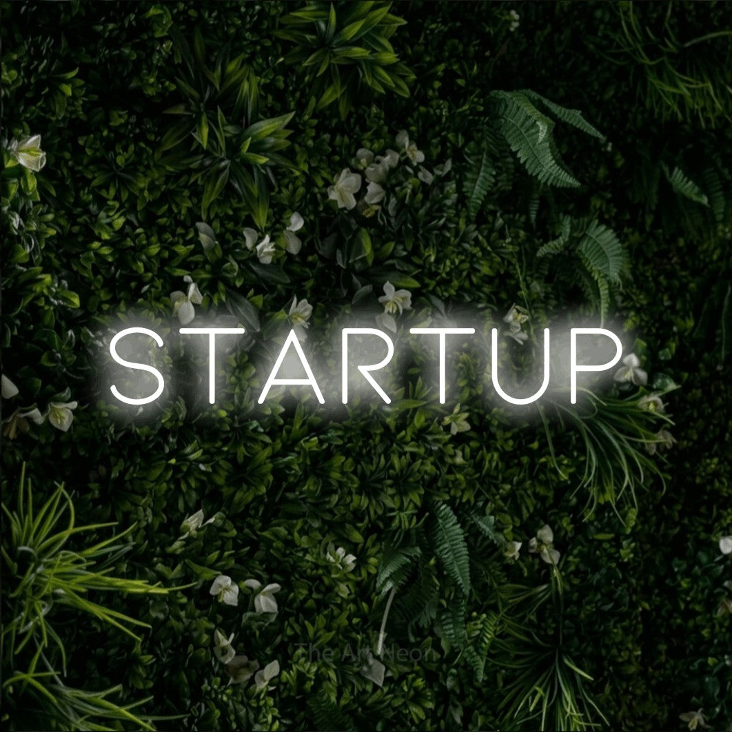 LED neon sign reading “Startup”, arranged in a single line.