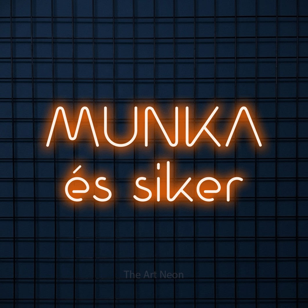 LED neon sign reading “MUNKA és siker”, arranged in two lines.