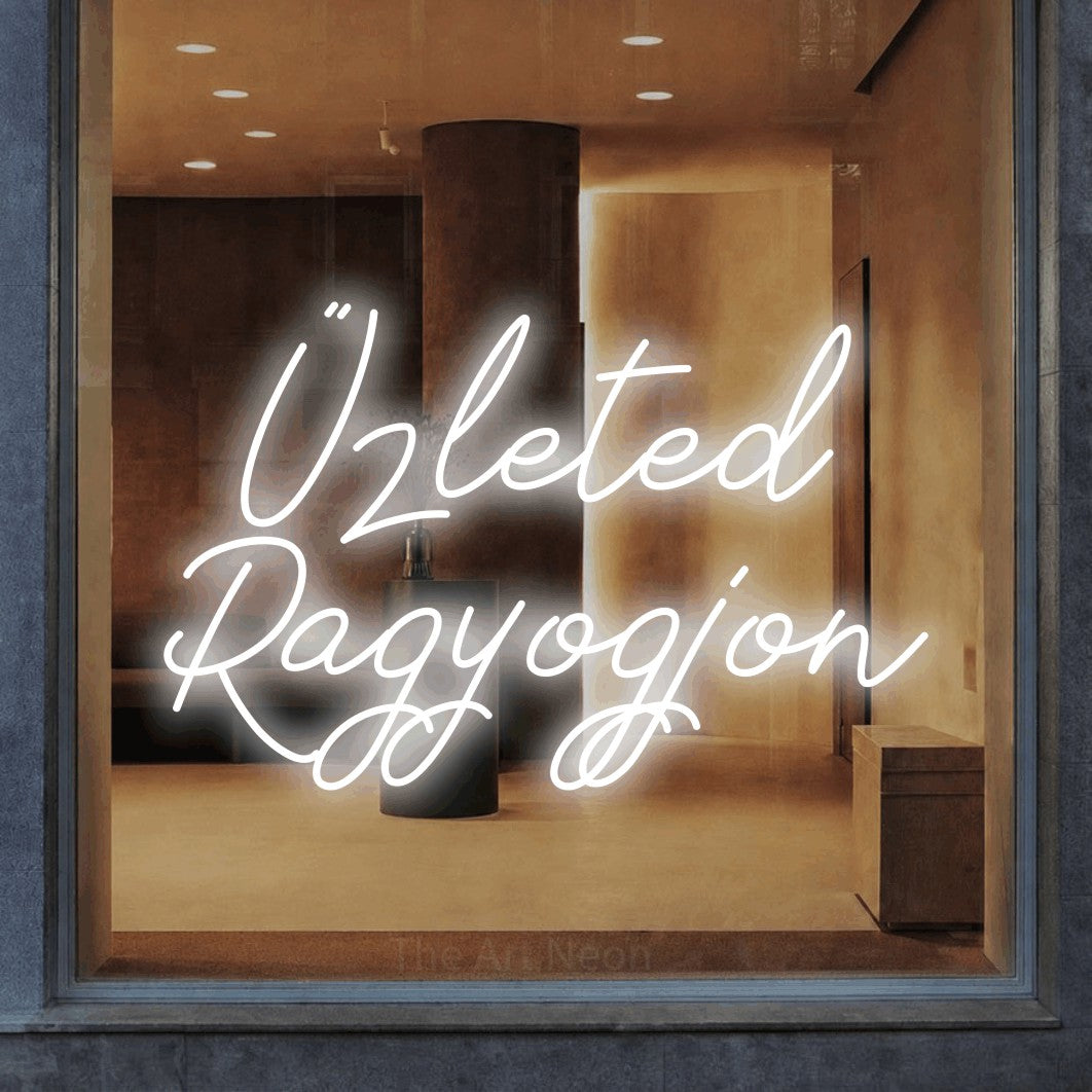 LED neon sign reading “Üzleted Ragyogjon”, arranged in two lines.