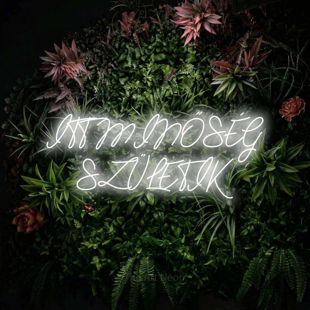 LED neon sign reading “ITT MINŐSÉG SZÜLETIK”, arranged in two lines.