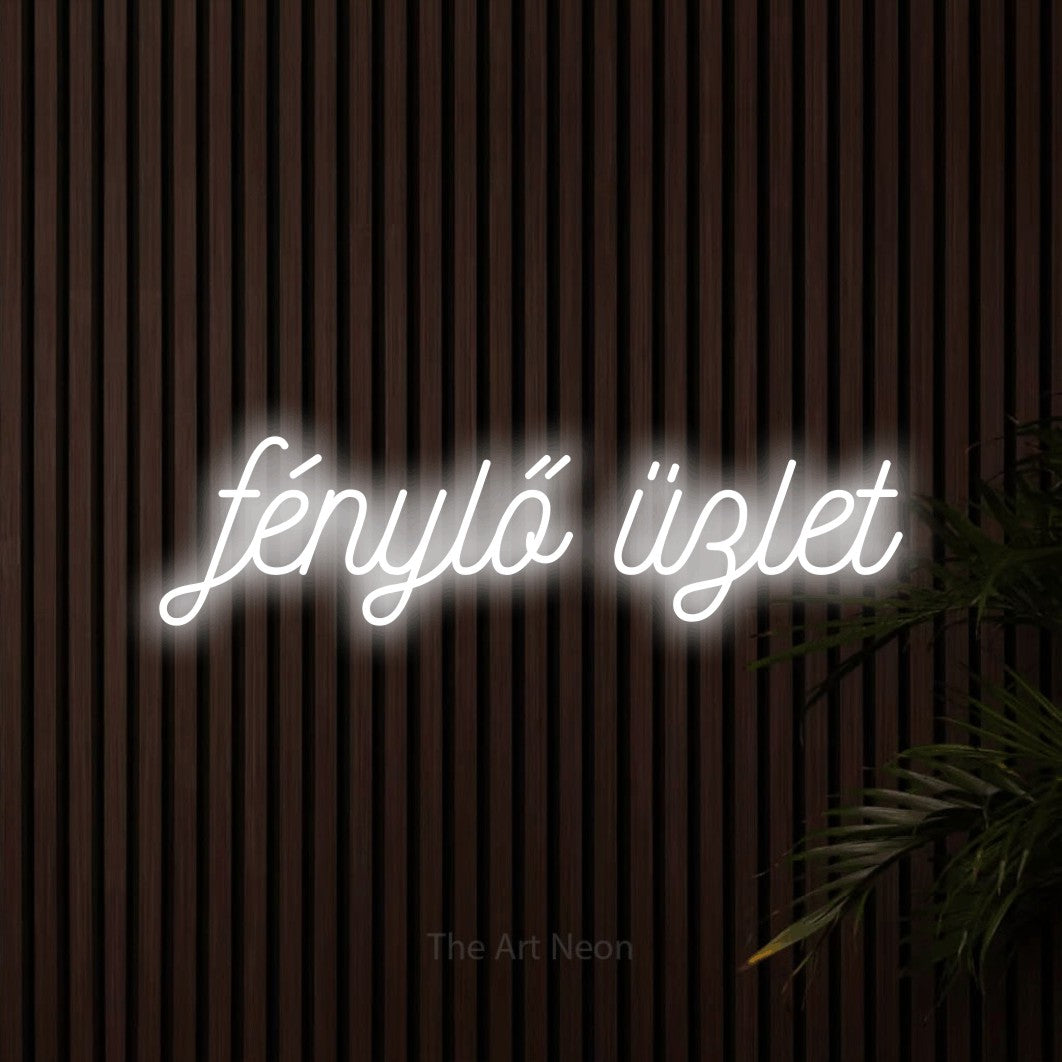 LED neon sign reading “fénylő üzlet”, arranged in a single line.
