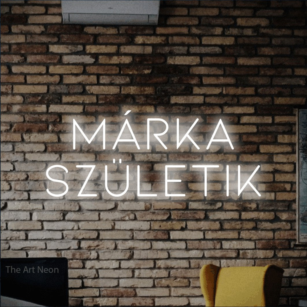 LED neon sign reading “márka születik”, arranged in two lines.