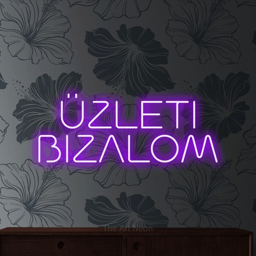 LED neon sign reading “ÜZLETI BIZALOM”, arranged in two lines.