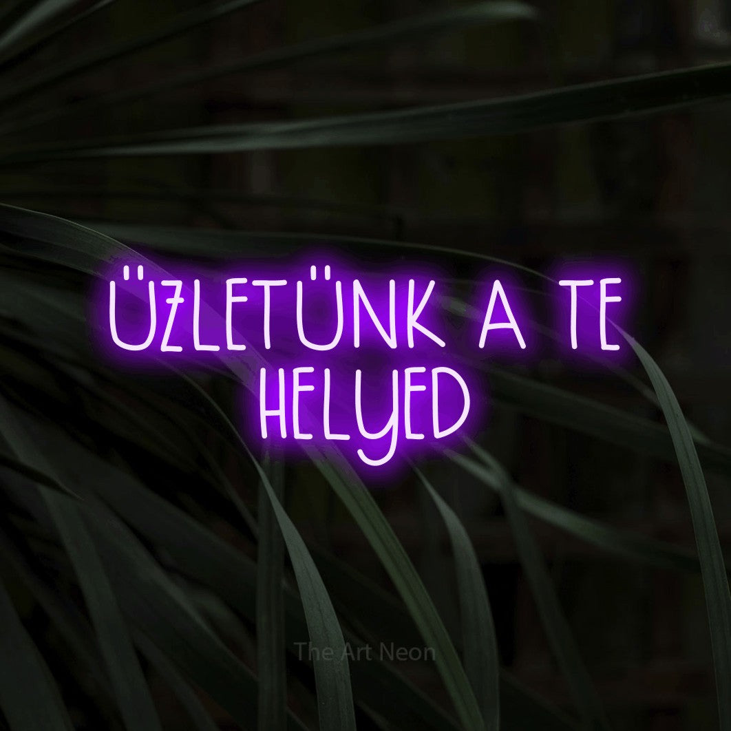 LED neon sign reading “ÜZLETÜNK A TE HELYED”, arranged in two lines.