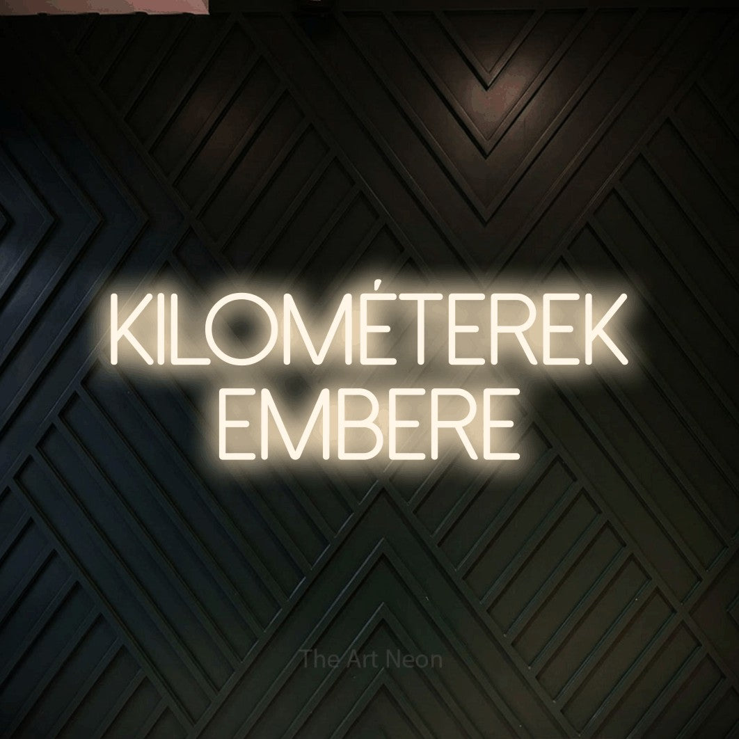 LED neon sign reading “kilométerek embere”, arranged in two lines.