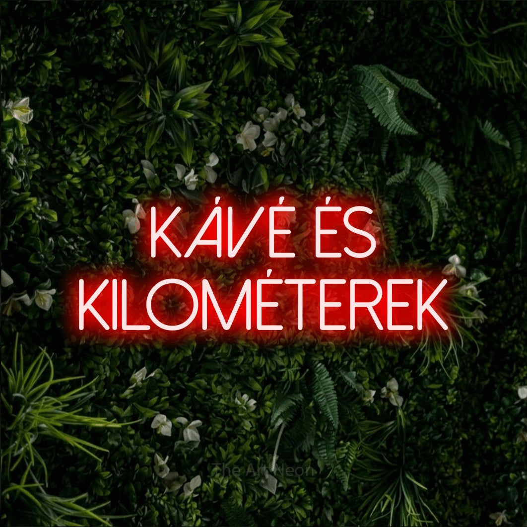 LED neon sign reading “kávé és KILOMÉTEREK”, arranged in two lines.