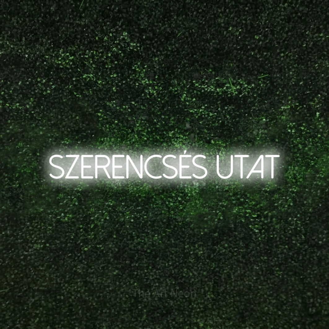 LED neon sign reading “SZERENCSÉS UTAT”, arranged in a single line.