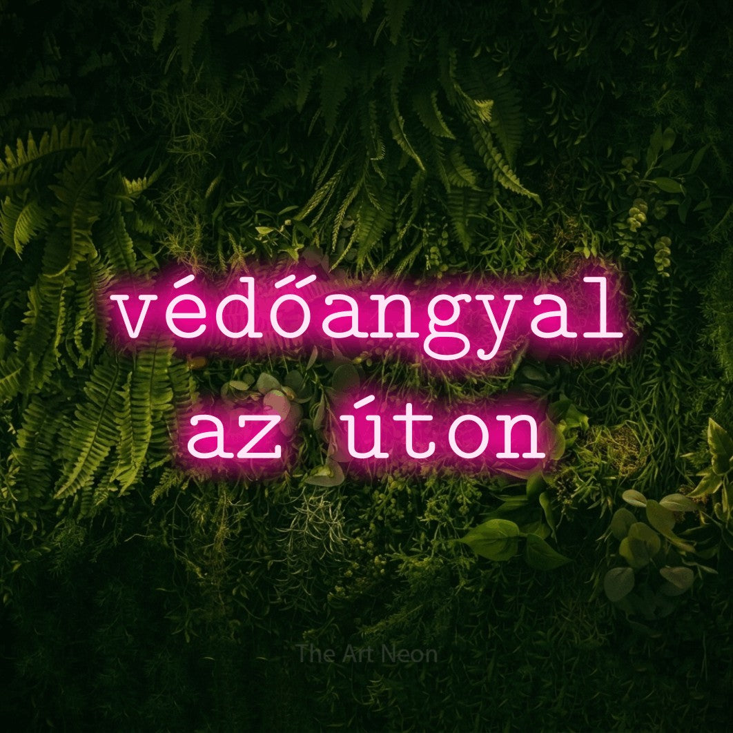 LED neon sign reading “védőangyal az úton”, arranged in two lines.