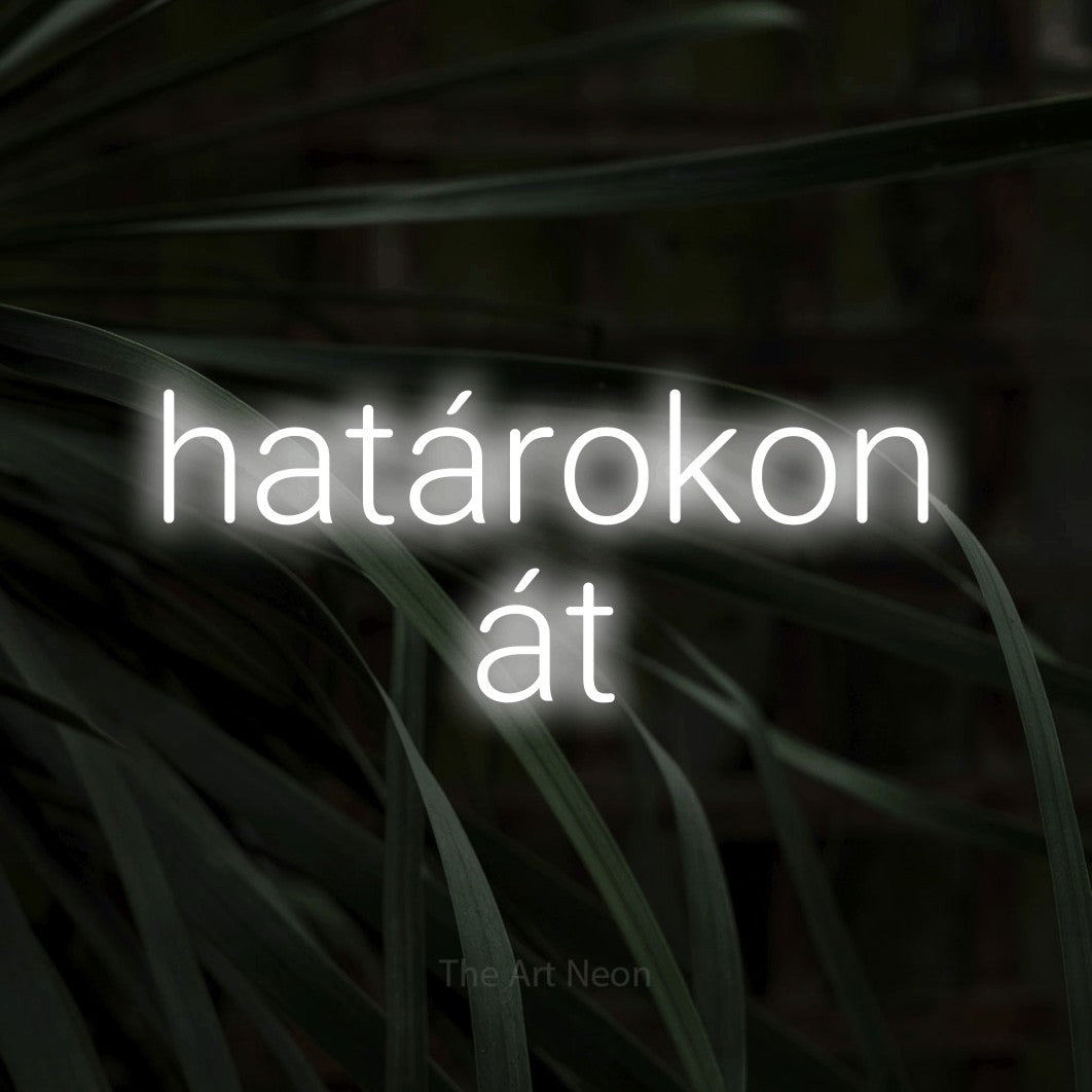 LED neon sign reading “határokon át”, arranged in two lines.