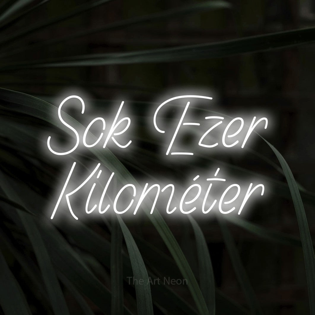 LED neon sign reading “Sok Ezer Kilométer”, arranged in two lines.